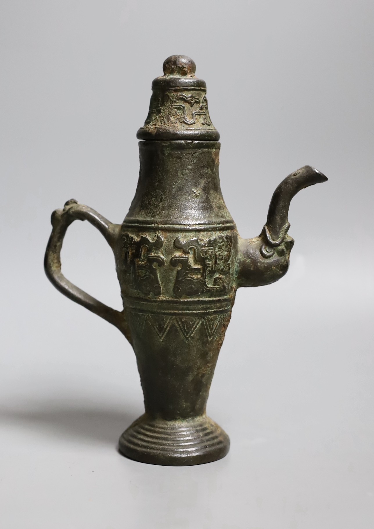 A Chinese archaistic bronze pouring vessel and cover, 17th/18th century, 22cms high